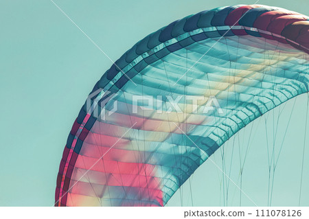 Colorful paraglider close-up against the blue sky 111078126