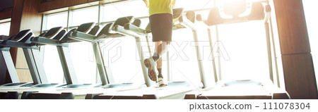 Cardio workout. Rear view of a mature athletic man in sportswear running on a treadmill in a gym, full length 111078304