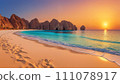 Sunset beach: rocks and footprints on the sand 111078917