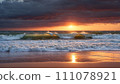Cloudy sunset: coastal tranquility 111078921