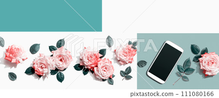 Smartphone with pink roses overhead view 111080166