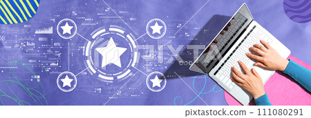 Rating star concept with person using a laptop Rating star concept with person using a laptop 111080291