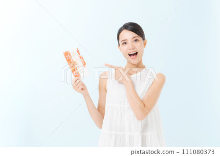 A young lady with a gift bag 111080373