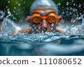 A swimmer wearing swim goggles in a pool. 111080652