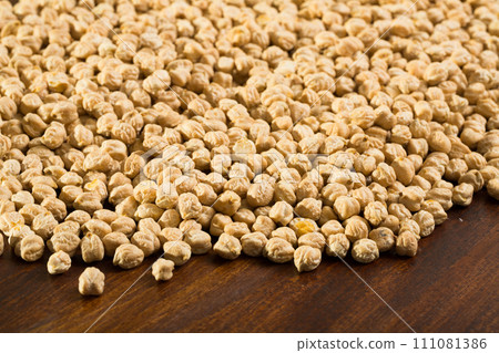 Uncooked chickpea on wooden surface 111081386