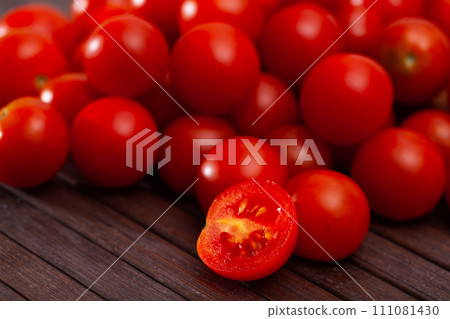Close up of red cherry tomato on table Close up of red cherry tomato on table 111081430