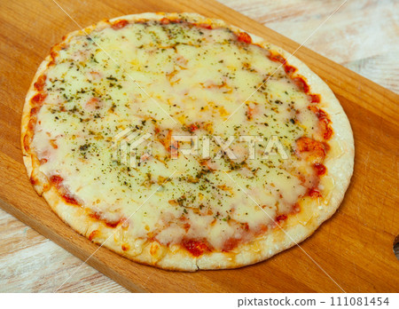 Just baked pizza served on wooden board Just baked pizza served on wooden board 111081454