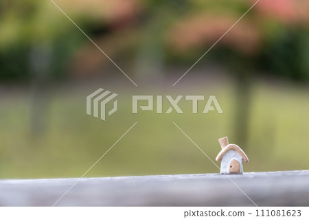 A small cute house with an unglazed chimney 111081623