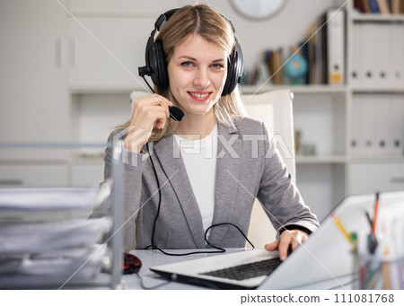 Call center woman operator with headset talking with client 111081768