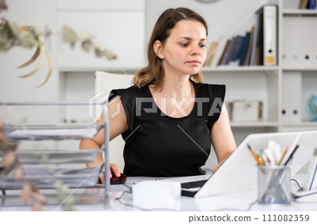 Female employee having productive day at work in office 111082359