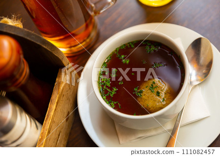 Beef soup with liver dumplings served on table Beef soup with liver dumplings served on table 111082457