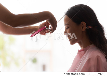 Female customer getting hair cut Female customer getting hair cut 111082973