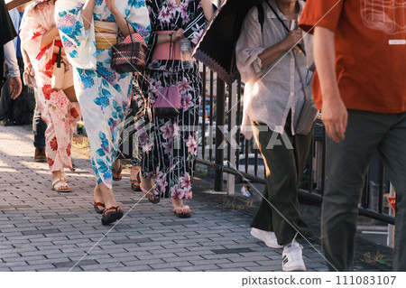 People heading to a fireworks display on a summer evening 111083107