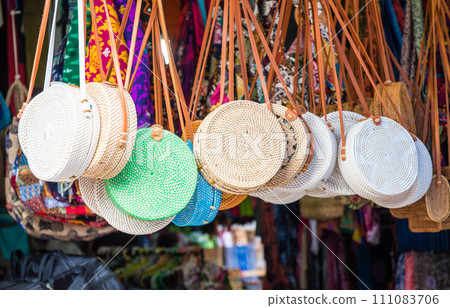 Iconic rattan hand bags hanging for souvenir at a street shop in Ubud market of Bali island, Indonesia. Iconic rattan hand bags hanging for souvenir at a street shop in Ubud market of Bali island, Indonesia. 111083706