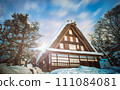 Traditional Japanese house covered in snow 111084081