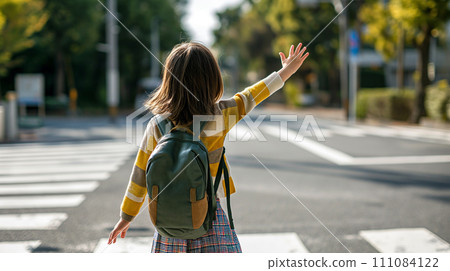 Elementary school student crossing a pedestrian crossing 111084122