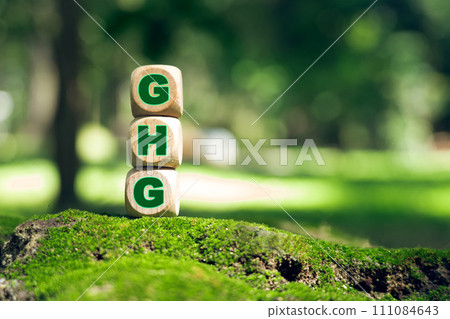 Business concept and GHG greenhouse gas symbol. Use the word GHG Greenhouse Gas on cubes and blocks. 111084643