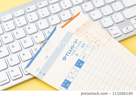 Keyboard and time card on yellow background 111086180