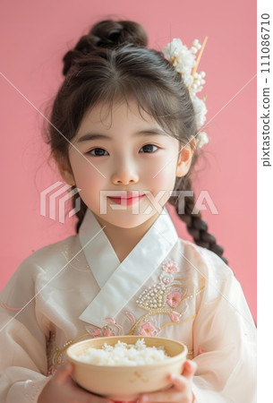 a girl happily enjoying yakbap on pink background a girl happily enjoying yakbap on pink background 111086710