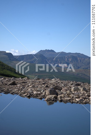 View of Mt. Tomuraushi from the pooled water of Itagaki Snow Valley at the end of summer View of Mt. Tomuraushi from the pooled water of Itagaki Snow Valley at the end of summer 111087701