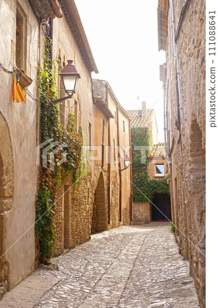 Spain. Coast of the Costa Brava. Catalonia. Streets of a small town. Old village in Spain. Charming old streets. A typical village with beautiful stone houses. Beautiful sunset Spain. Coast of the Costa Brava. Catalonia. Streets of a small town. Old village in Spain. Charming old streets. A typical village with beautiful stone houses. Beautiful sunset 111088641