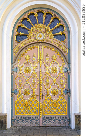 A gilded door decorated with exquisite carvings, the entrance to one of the boundaries of the Pochaev Lavra. View Pochaev Lavra to Pochaev, a city in western Ukraine. A gilded door decorated with exquisite carvings, the entrance to one of the boundaries of the Pochaev Lavra. View Pochaev Lavra to Pochaev, a city in western Ukraine. 111088659