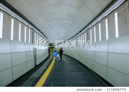 Nov 26 2023 Modern city subway station with commuters on the platform. Nov 26 2023 Modern city subway station with commuters on the platform. 111088770