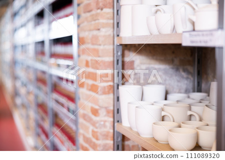 Pottery stands on wooden rack in pottery shop Pottery stands on wooden rack in pottery shop 111089320