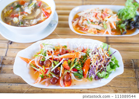 spicy salad serve with grape and crab sticks,Thai food spicy salad serve with grape and crab sticks,Thai food 111089544