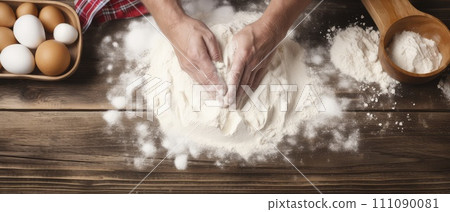 Person Kneading Dough on Wooden Table 111090081