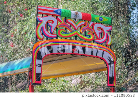 Mexico City, Mexico. Jan 11, 2024. A close up to a colorful sign of a Trajinera a gondola style boat along the Xochimilco canals. 111090558