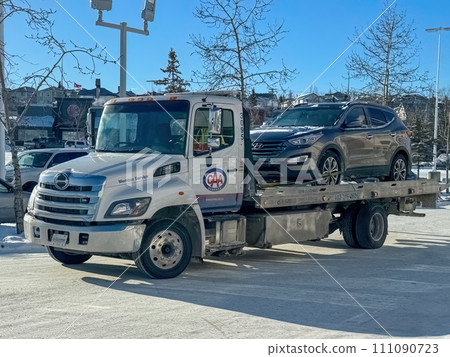 Calgary, Alberta, Canada. Jan 21, 2024. A Roadside Assistance Across Alberta or AMA truck Towing a car during the winter. Calgary, Alberta, Canada. Jan 21, 2024. A Roadside Assistance Across Alberta or AMA truck Towing a car during the winter. 111090723