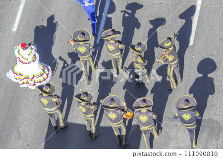 Calgary, Alberta, Canada. Jul 10, 2023. Looking down from above as a Mariachi band plays on a street during the Calgary Stampede parade. Calgary, Alberta, Canada. Jul 10, 2023. Looking down from above as a Mariachi band plays on a street during the Calgary Stampede parade. 111090810