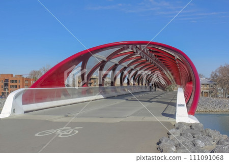 Calgary, Alberta, Canada. Jul 10, 2023. Inside view to the Peace Bridge that accommodates people walking and cycling across the Bow River. Calgary, Alberta, Canada. Jul 10, 2023. Inside view to the Peace Bridge that accommodates people walking and cycling across the Bow River. 111091068