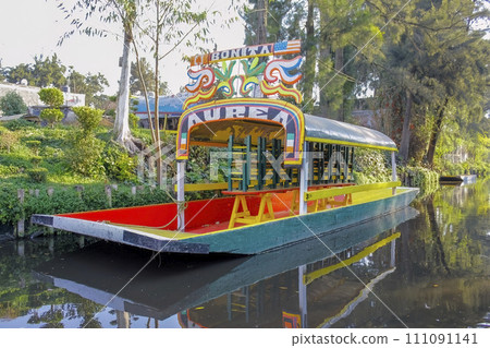 Mexico City, Mexico. Jan 11, 2024. A close up to an empty parked Trajinera a gondola style boat or colourful raft, along the Xochimilco canals. 111091141