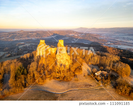 Trosky medieval castle ruins at cold morning sunrise time. Bohemian Paradise, Czech: Cesky raj, Czechia. Aerial view from above. 111091185
