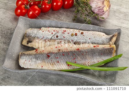 Marinated herring fillet with green onion Marinated herring fillet with green onion 111091710