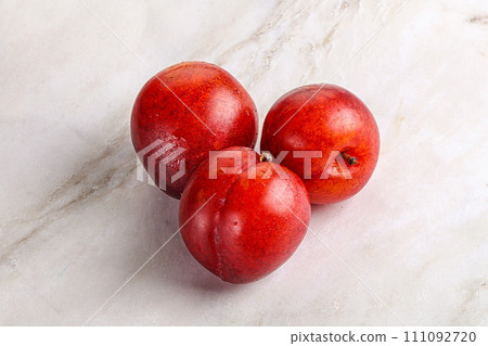 Ripe sweet juicy red plum 111092720