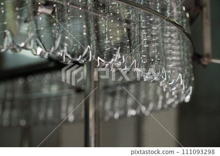 Clean bottles rotating in assembly line Clean bottles rotating in assembly line 111093298