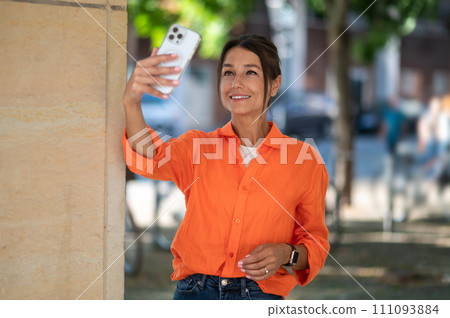 Cute woman in bright shirt making selfie 111093884