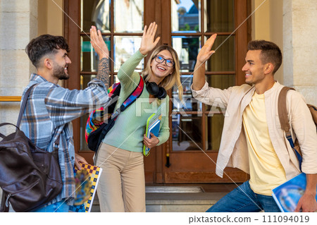 Young happy students having fun together outside university giving high five. Young happy students having fun together outside university giving high five. 111094019
