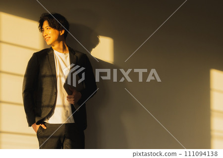 Man by the window in the evening 111094138