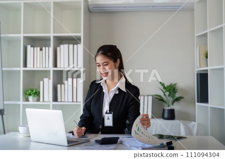 Business accounting woman counting on calculator working on financial document in hands closeup. Bookkeeping concept Business accounting woman counting on calculator working on financial document in hands closeup. Bookkeeping concept 111094304