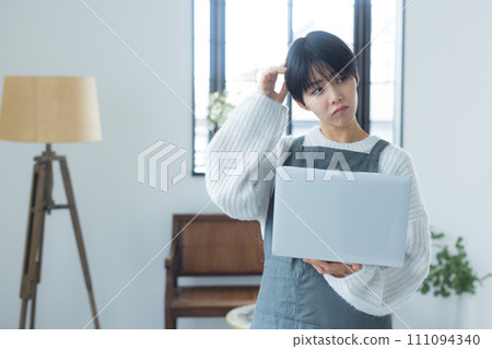 A woman using a computer A woman using a computer 111094340