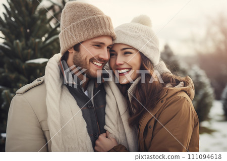 Young couple in warm clothes is hugging and smiling while walking in winter park or forest Young couple in warm clothes is hugging and smiling while walking in winter park or forest 111094618
