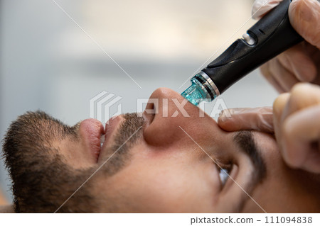 Man having cosmetological procedures in a beauty clinic 111094838