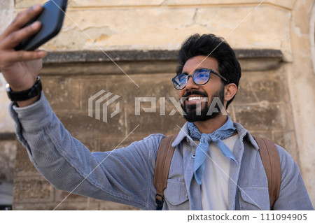 Young hindu man in eyeglasses feeling happy and contented 111094905