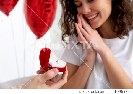 Man makes a proposal with the engagement ring at the Valentines day celebration 111096574