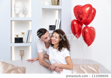 A couple hugs each other at the Valentines day celebration 111096600