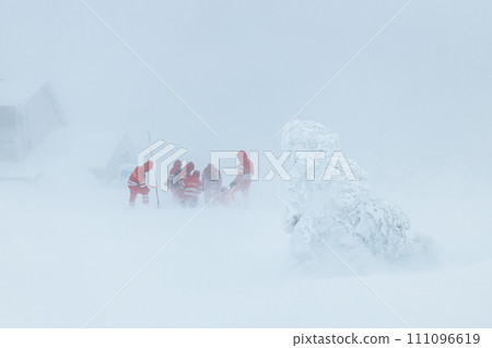 Team of emergency service in winter in mountains. 111096619